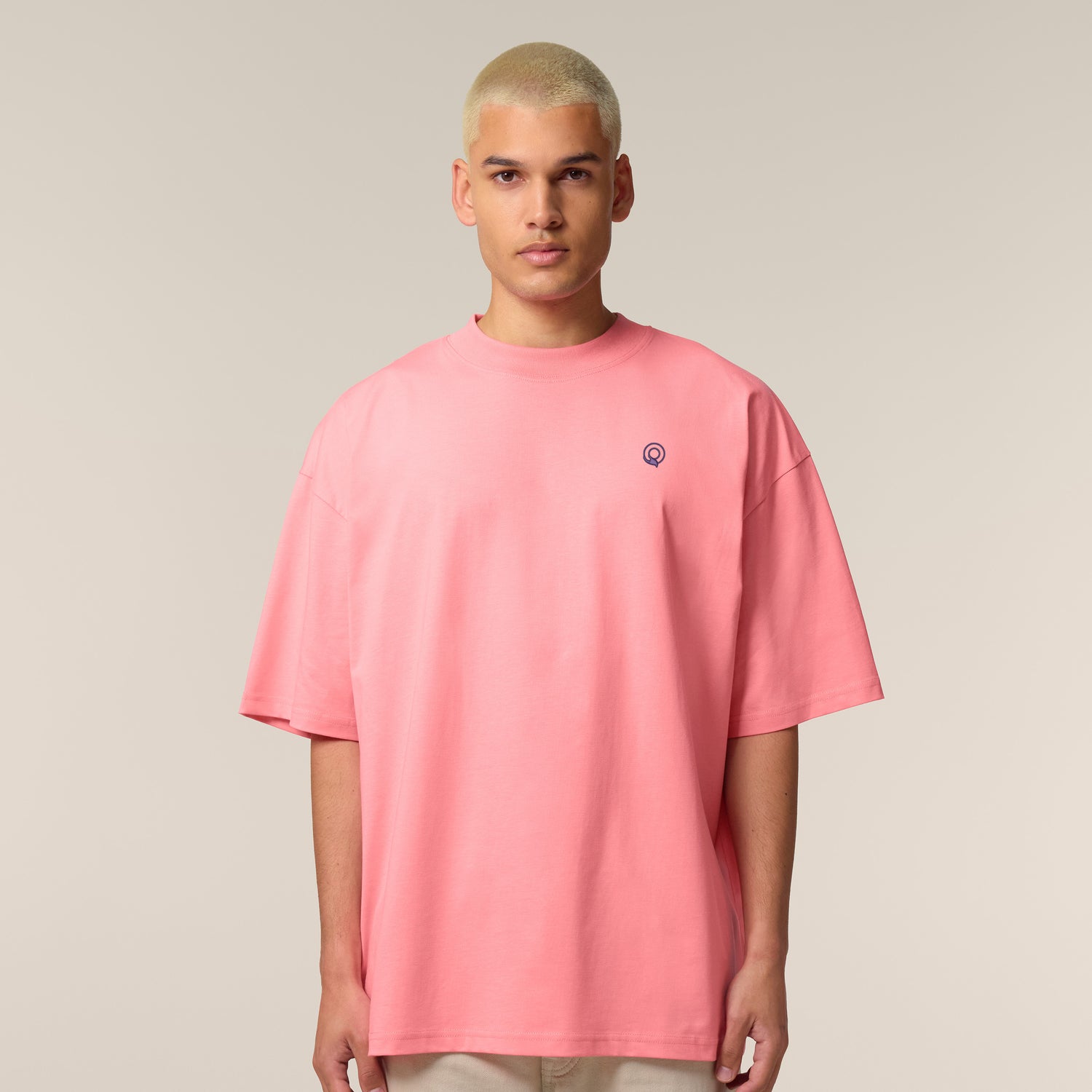 Male model wearing a pink joy oversized unisex t-shirt – sustainable and ethically made fashion by New World Guardians.