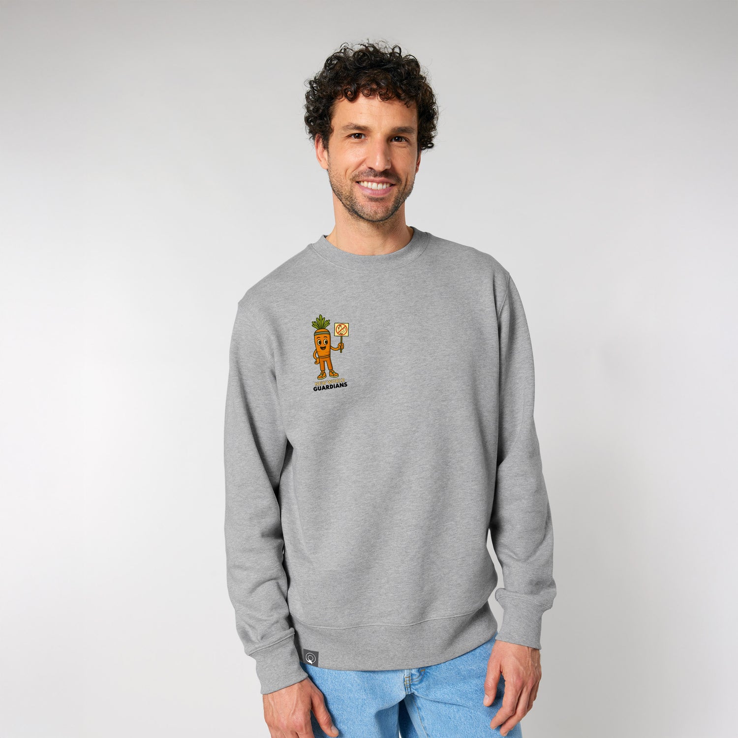 Male model wearing a heather grey NEW WORLD GUARDIANS unisex vegan sweater featuring Crunch the carrot in a comic-style front print and the full Roots for Our Future veggie squad with “Eat Us Not Them” slogan on the back. Made from 100% organic cotton. Sustainable streetwear and bold vegan fashion with personality.