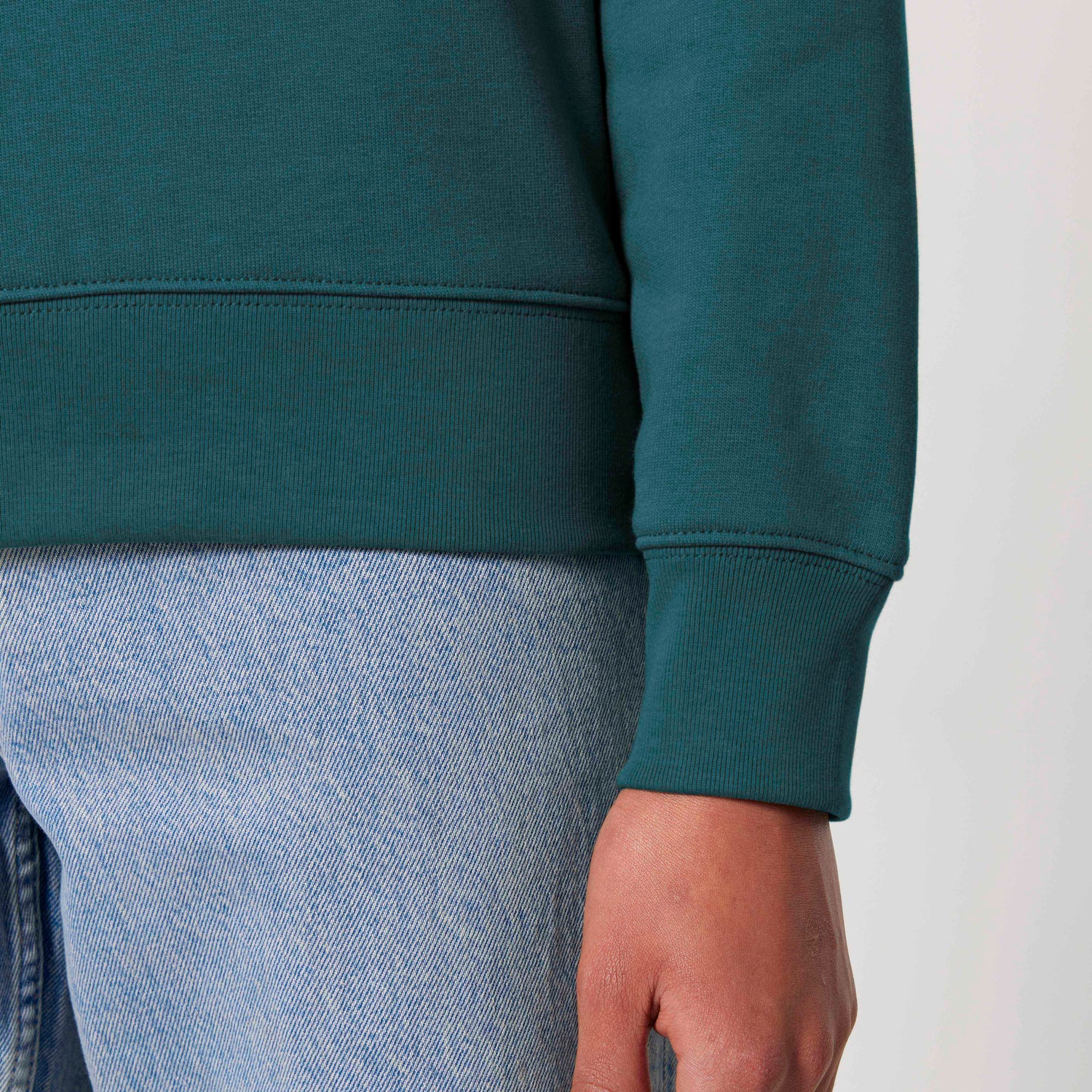 Close-Up of eco-friendly unisex sweater with ribbed cuffs and hem, made from GOTS-certified organic cotton, 20 colors