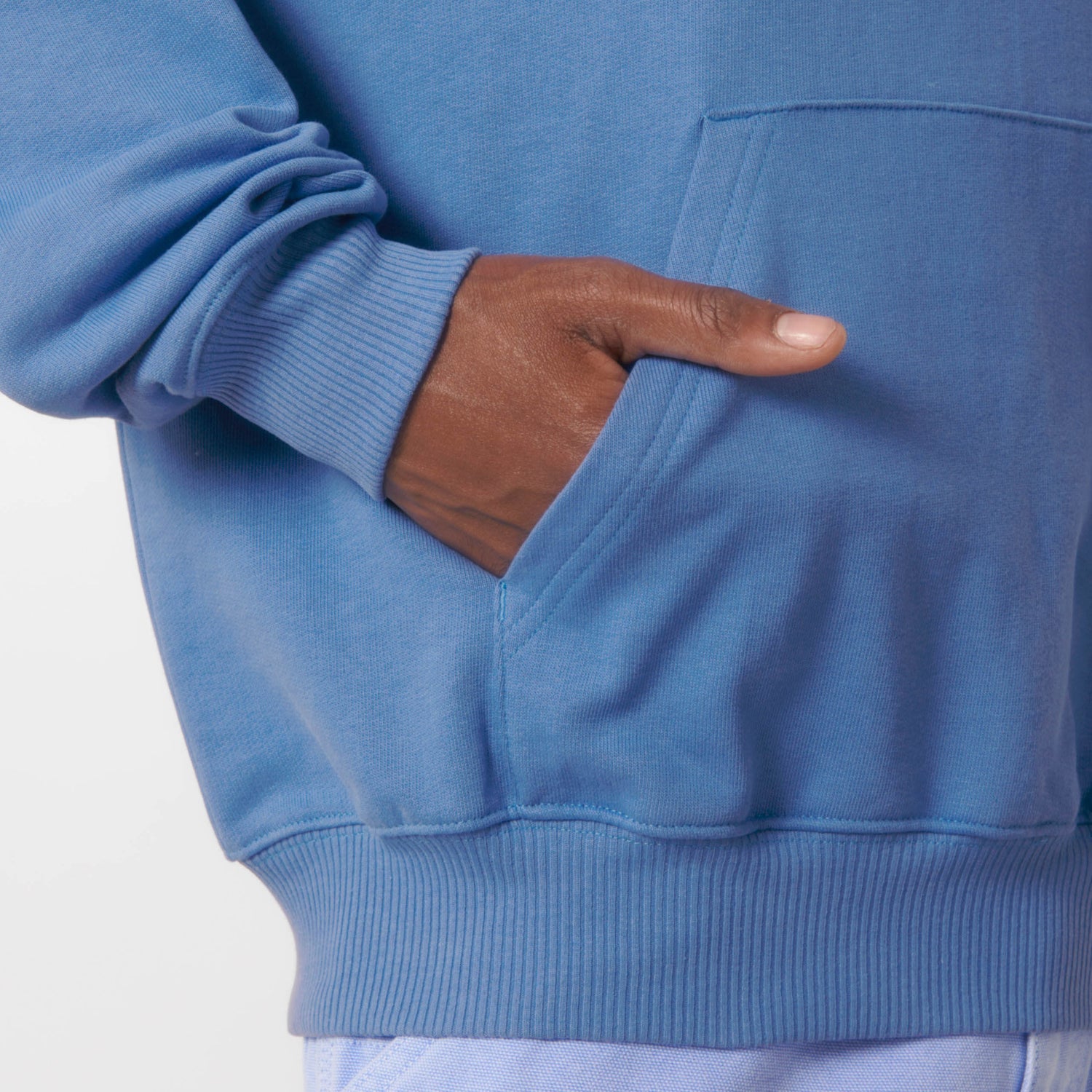 Male model wearing a bright blue hoodie with art print, made from 100% organic cotton – sustainable and ethically made fashion by New World Guardians.