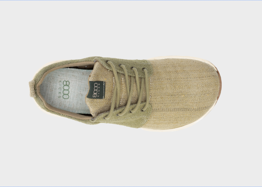 Green sneaker with a visible brand logo on a white background