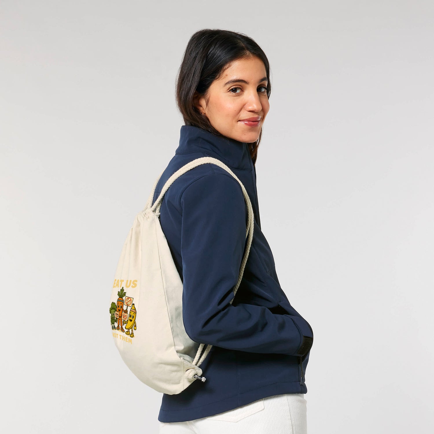 Woman Wearing Vegan Rebel Gym Bag in Beige – Sustainable Drawstring Backpack by NEW WORLD GUARDIANS