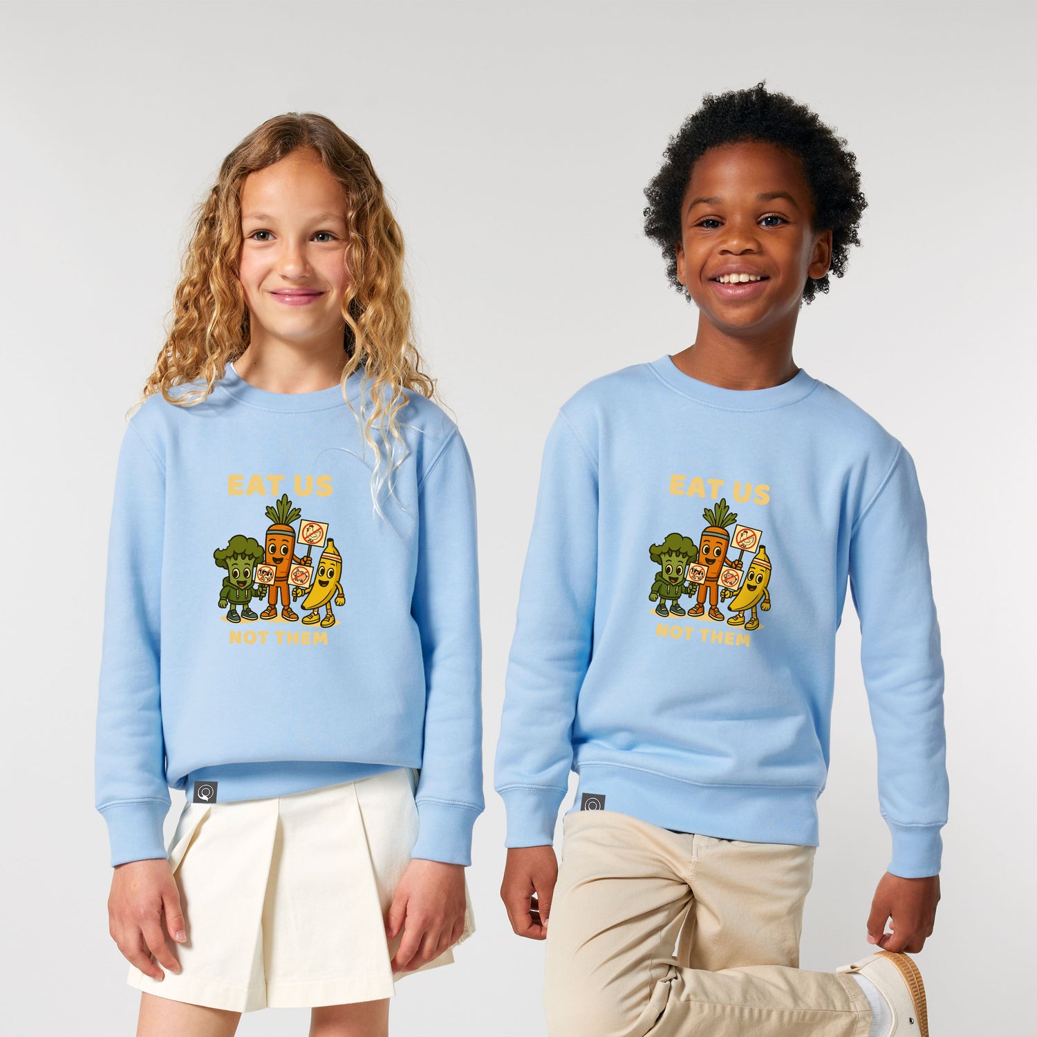 Two children wearing light blue sustainable sweatshirts with a colorful graphic design in organic cotton