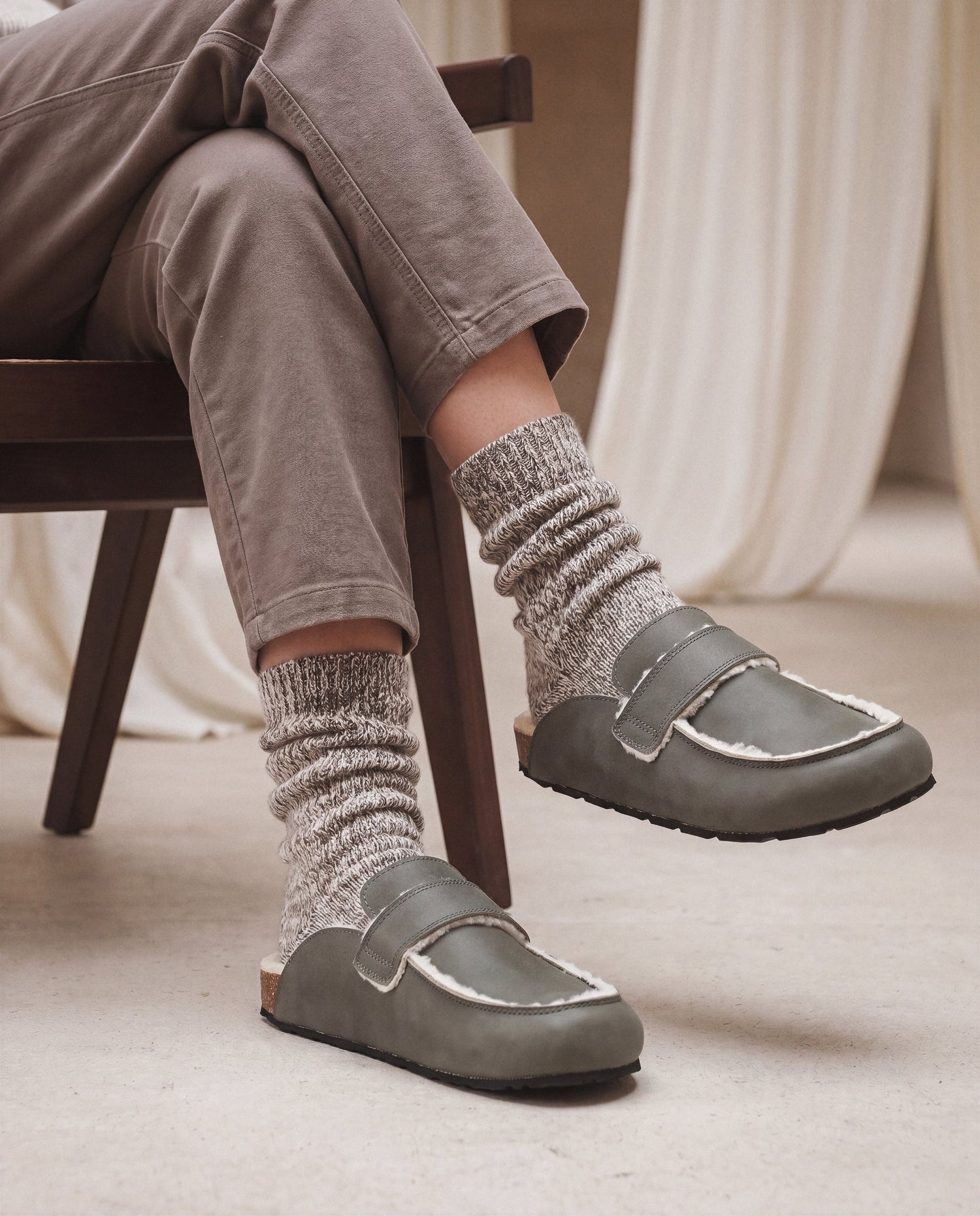 KOOD Green vegan clog worn by two models — unisex vegan clog in sage green styled with knitwear and tailored trousers, NAE Vegan Shoes