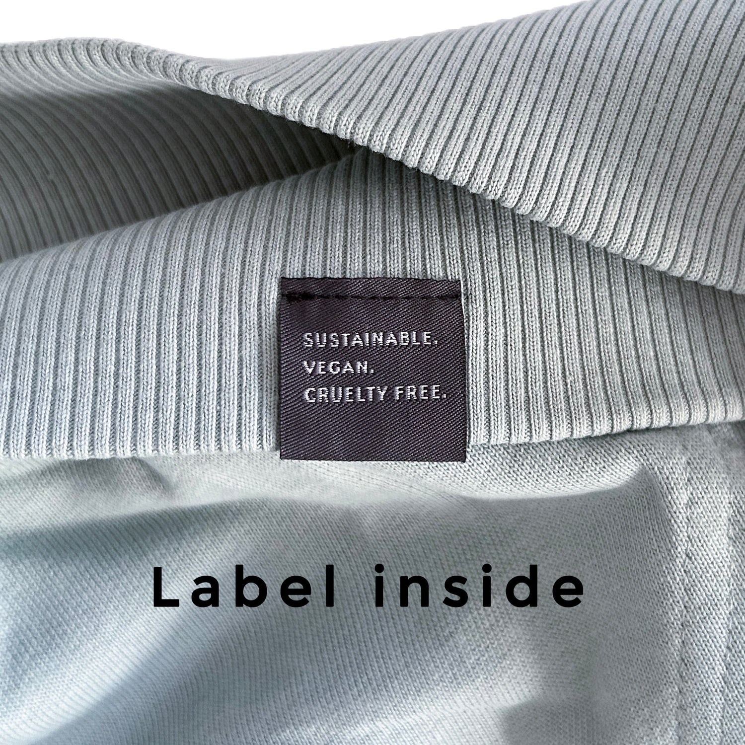New World Guardians sustainable Hoodie Close-Up with a label inside stating 'Sustainable, Vegan, Cruelty Free'.
