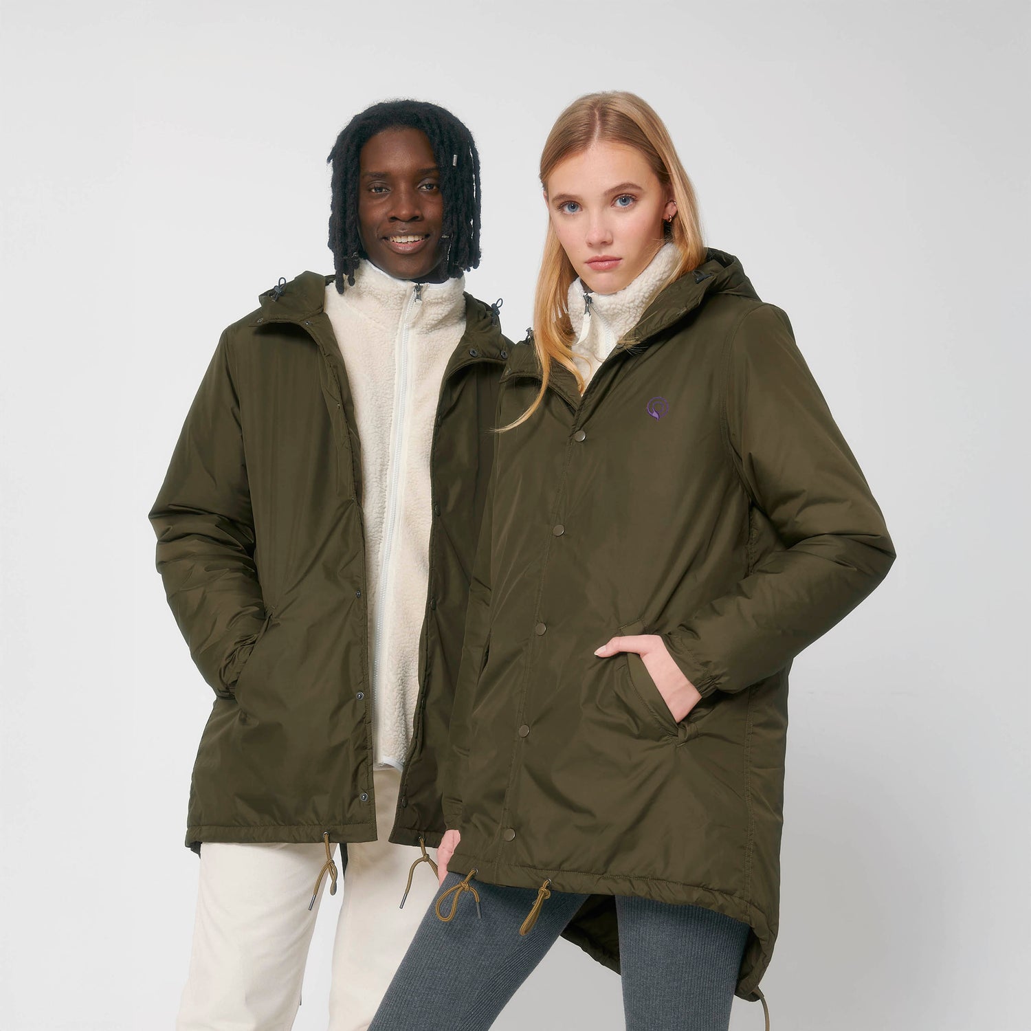 Two models wearing NEW WORLD GUARDIANS GUARDIAN padded parka in 100% recycled polyester, sustainable unisex winter coat, 3 colors available