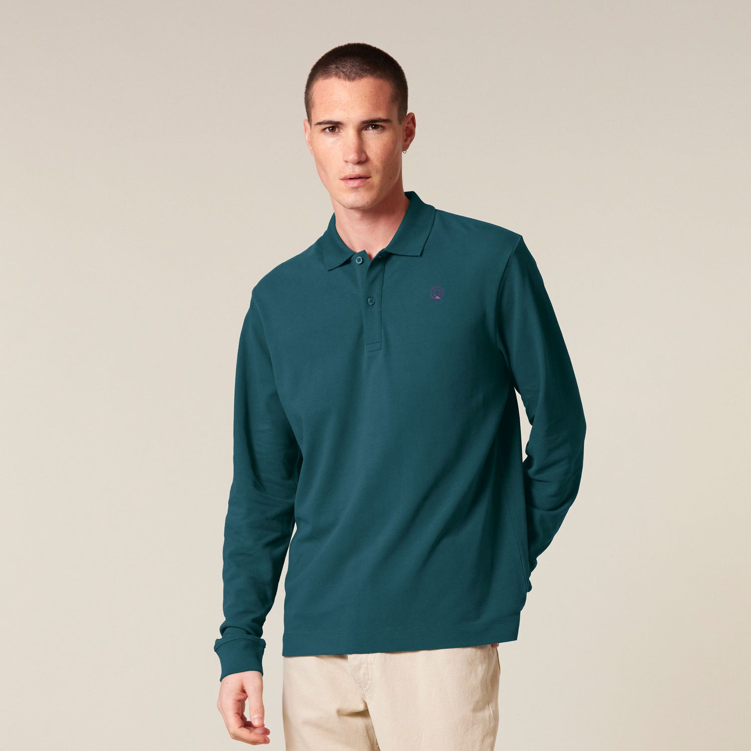 Male model wearing a black long sleeve unisex polo shirt – sustainable and ethically made fashion by New World Guardians.