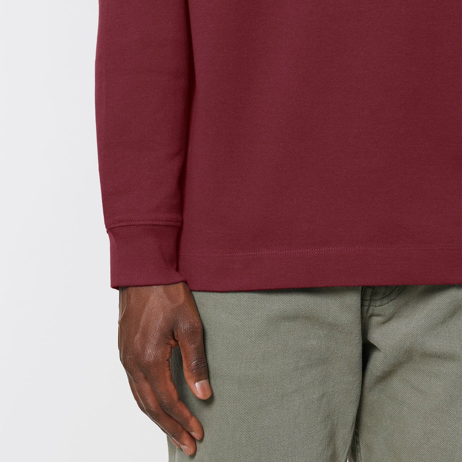 Male model wearing a black long sleeve unisex polo shirt – sustainable and ethically made fashion by New World Guardians.