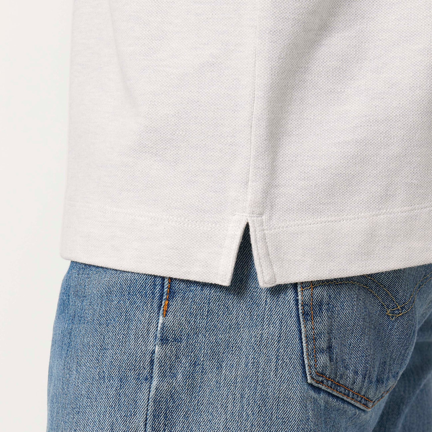 Close Up, Male model wearing a white unisex polo shirt – sustainable and ethically made fashion by New World Guardians.