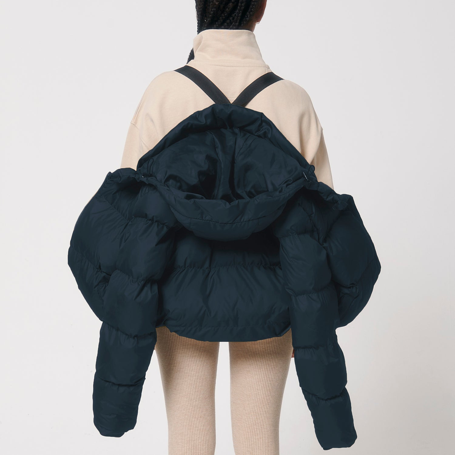 Back view of oversized recycled polyester puffer jacket with interior chest pocket and carry straps, sustainable design, 4 colors