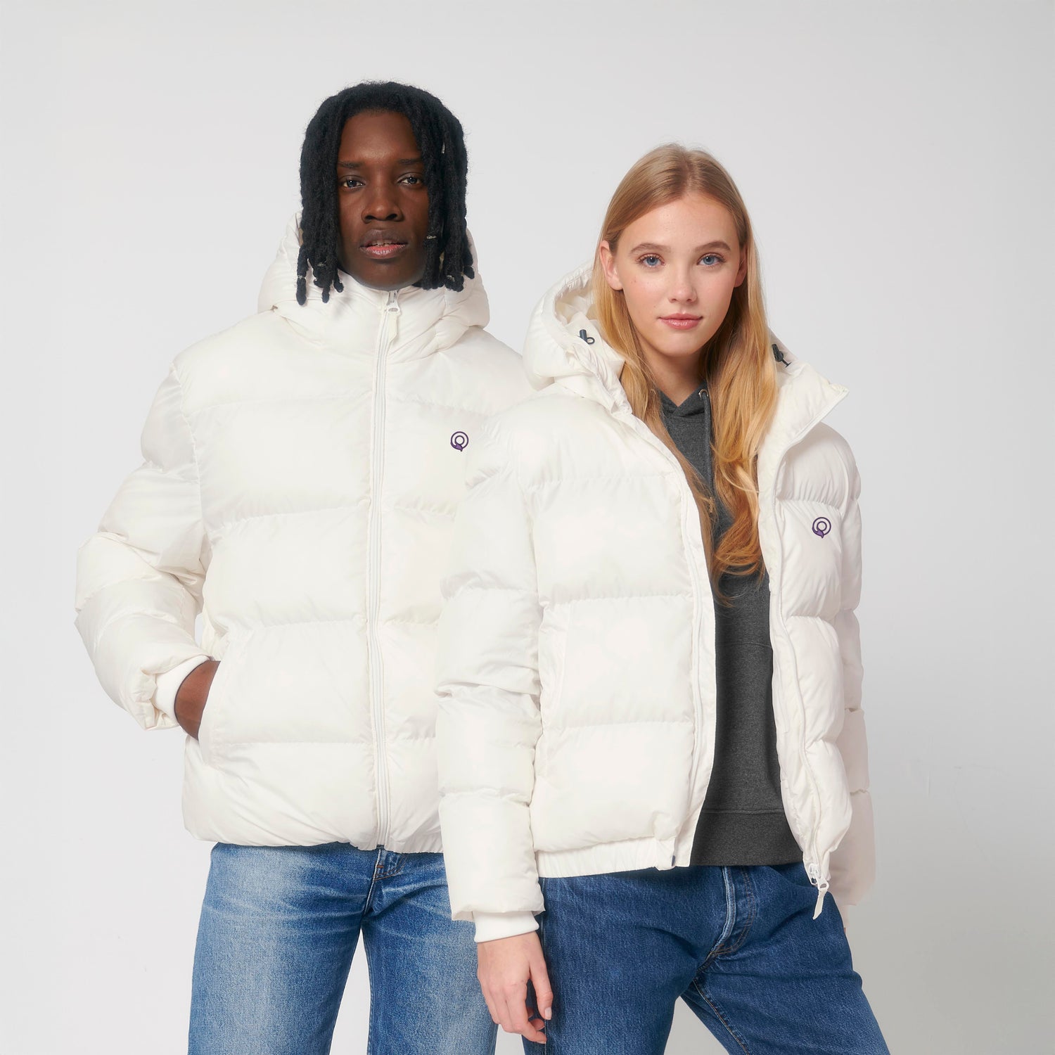 Two models wearing white vegan NEW WORLD GUARDIANS GUARDIAN puffer jacket in 100% recycled polyester, sustainable unisex outerwear, 4 color options