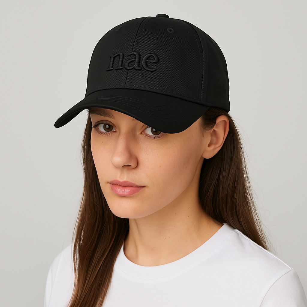 a woman wearing a black cap of organic cotton of nae vegan shoes