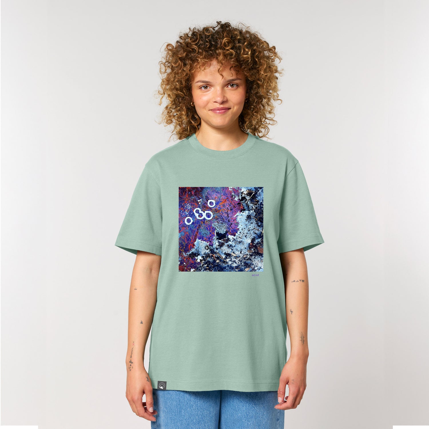 Female model wearing an aloe green t-shirt with art print, made from 100% organic cotton – sustainable and ethically made fashion by New World Guardians.