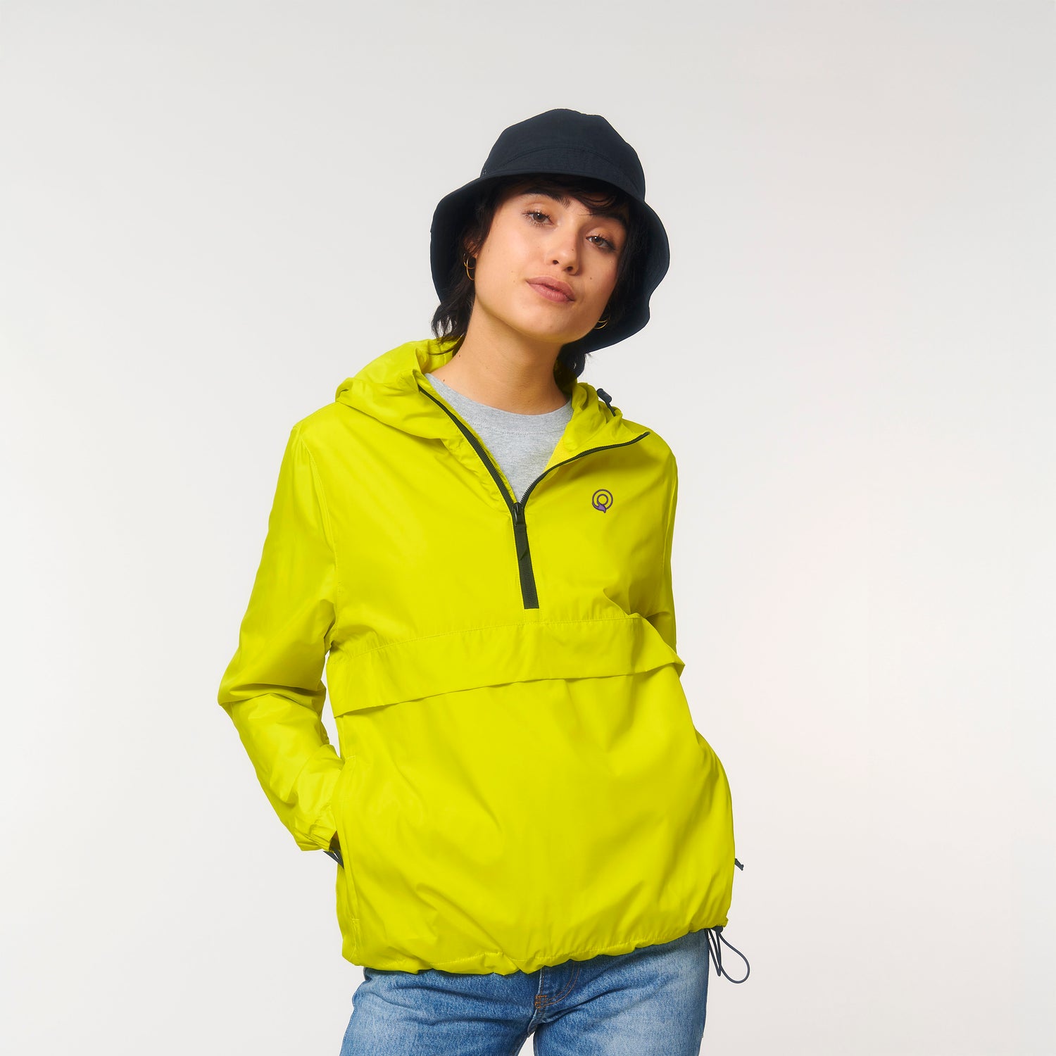 Female model wears the sustainable recycled polyester Guardian anorak with adjustable hood and elastic cuffs, NEW WORLD GUARDIANS style, 8 colors