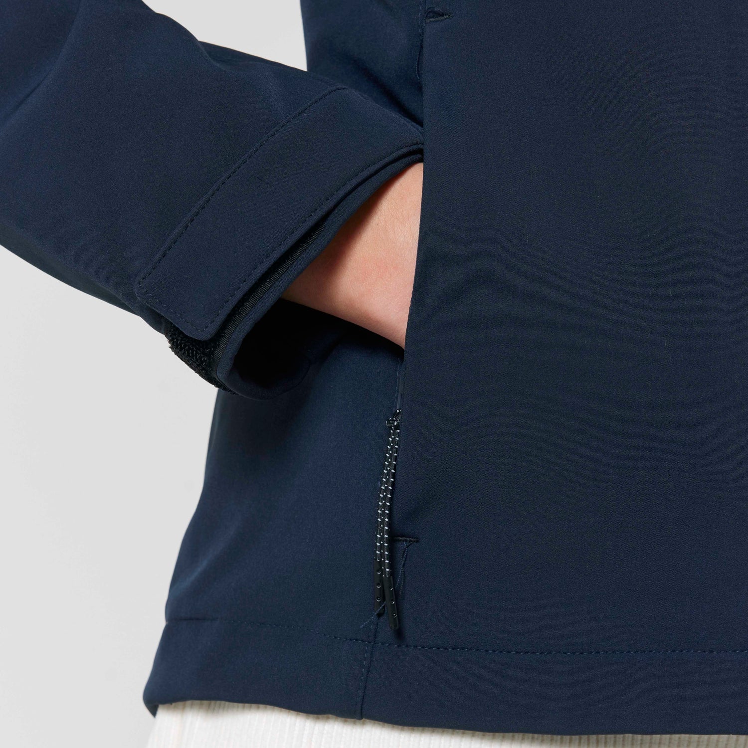 Close-Up of sustainable women’s softshell jacket with high collar, Velcro cuffs, and zippered pockets, eco-friendly outerwear