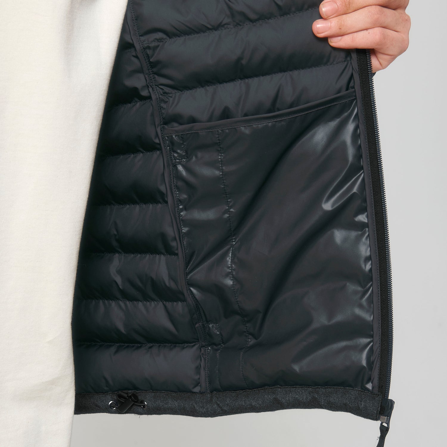 Inside of grey men’s sustainable padded jacket made from recycled polyester, structured fit, and adjustable cords, 2 colors