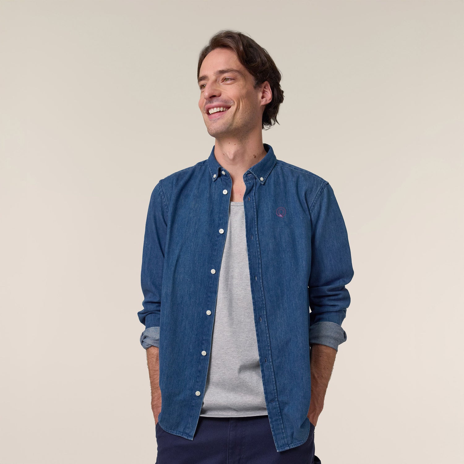 Male model wearing a denim shirt in mid wash – sustainable and ethically made fashion by New World Guardians.
