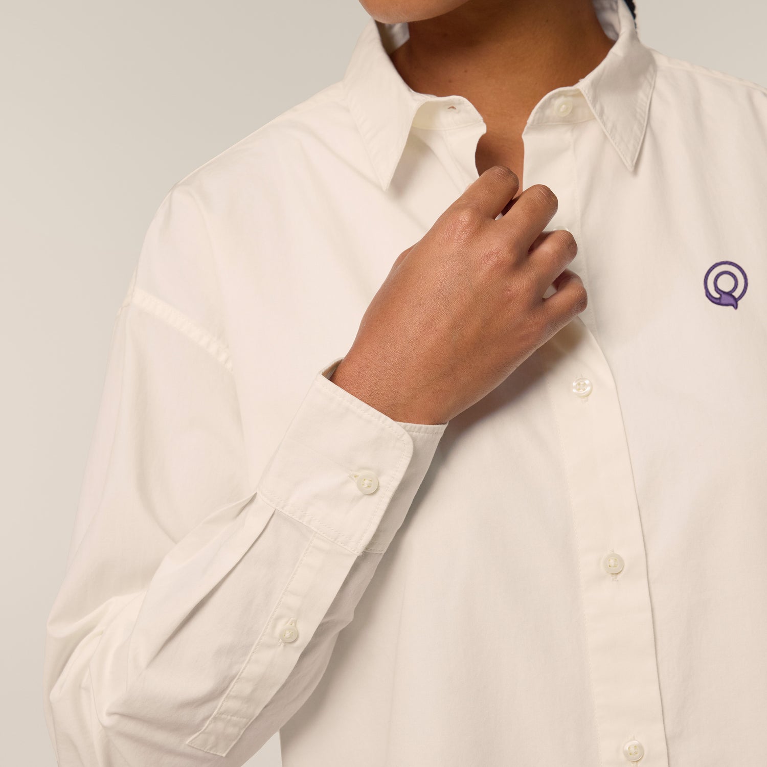 Female model wearing a cream-colored shirt – sustainable and ethically made fashion by New World Guardians.