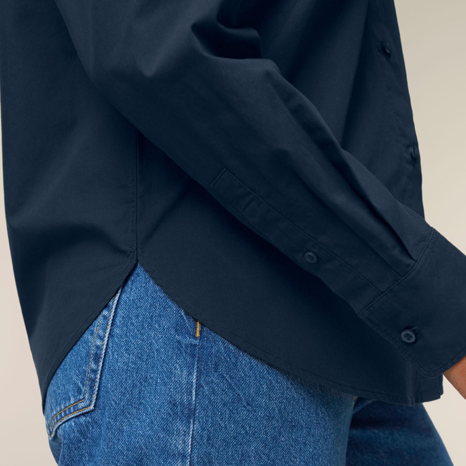 Female model wearing a French navy colored shirt – sustainable and ethically made fashion by New World Guardians.