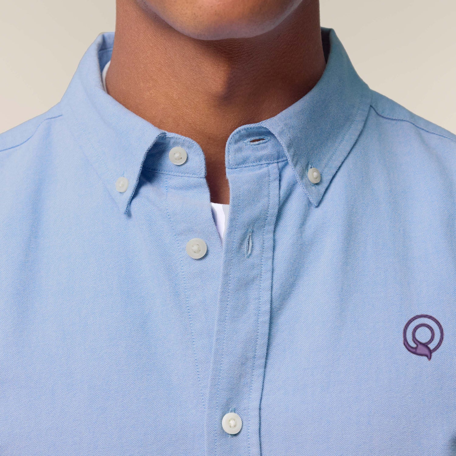 Male model wearing a blue Oxford shirt – sustainable and ethically made fashion by New World Guardians.