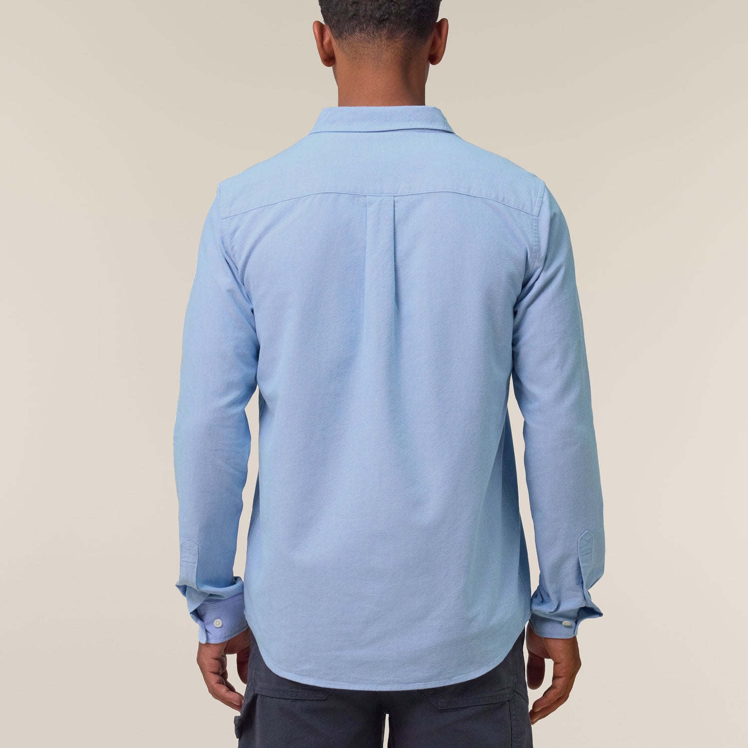Male model wearing a blue Oxford shirt – sustainable and ethically made fashion by New World Guardians.