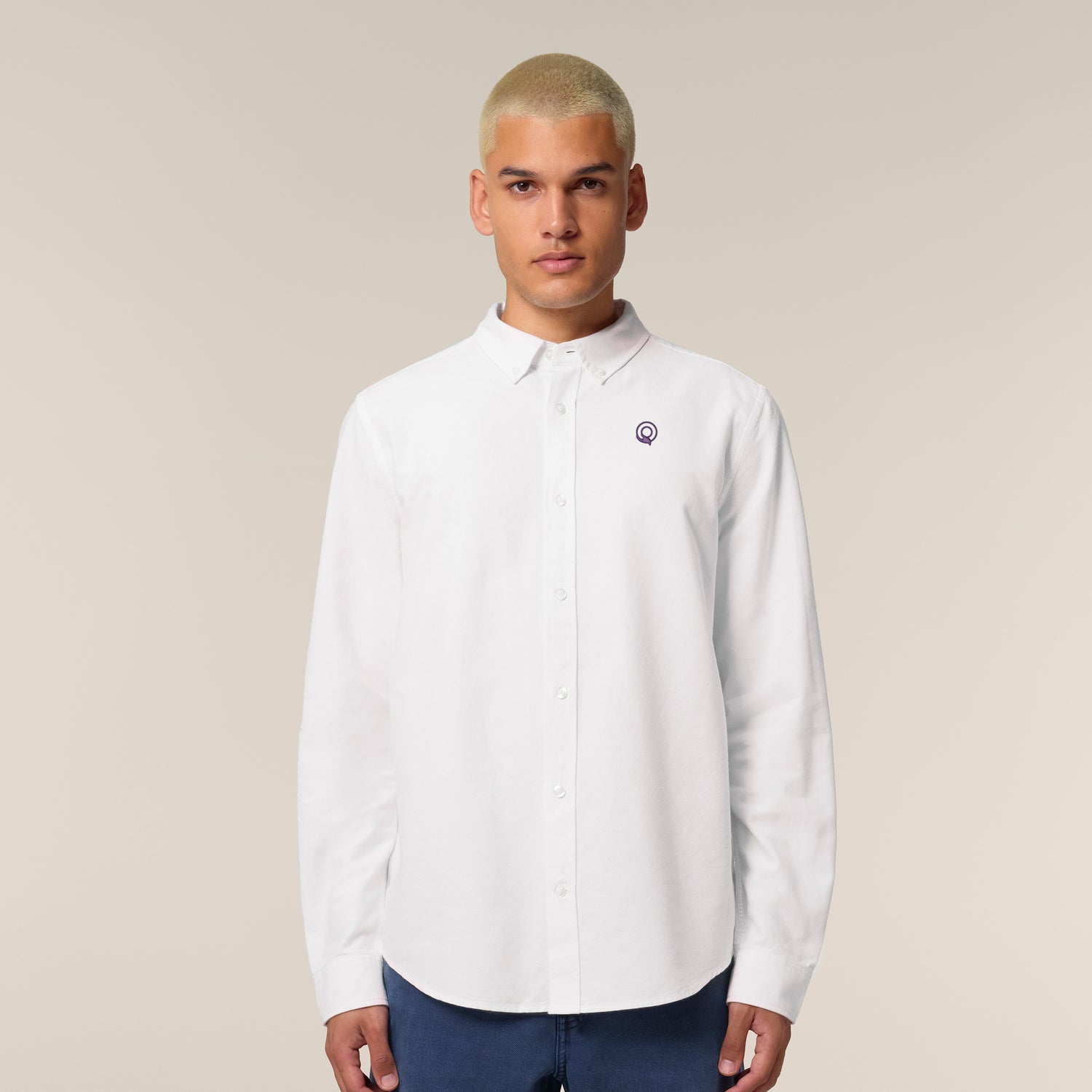Male model wearing a white Oxford shirt – sustainable and ethically made fashion by New World Guardians.