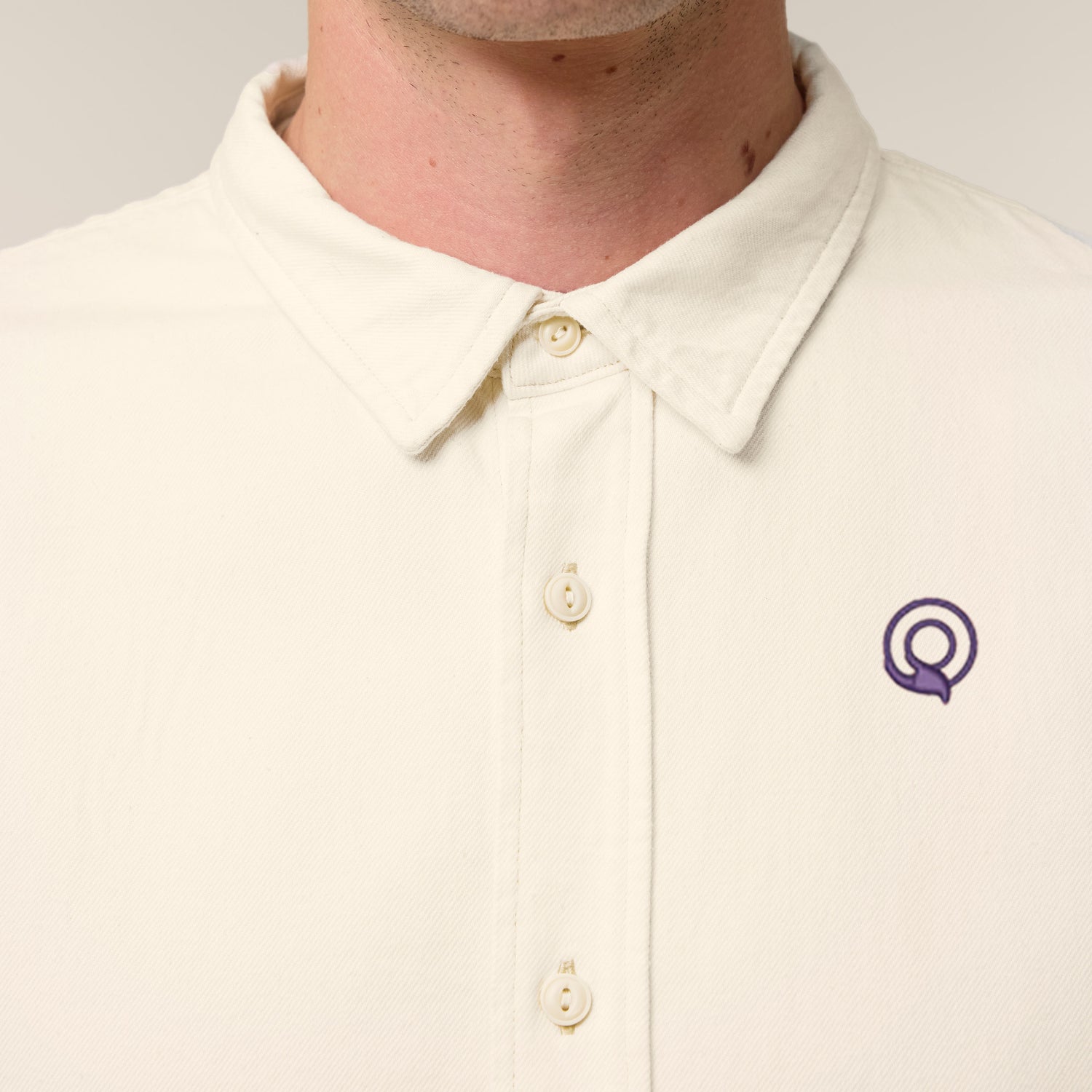 Male model wearing a natural raw worker shirt – sustainable and ethically made fashion by New World Guardians.