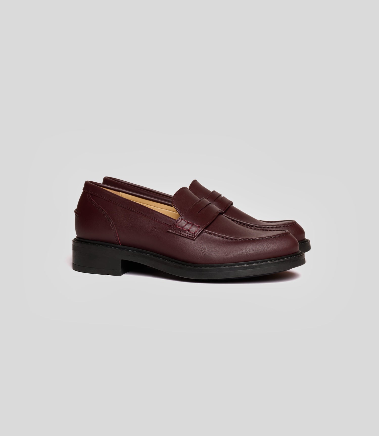 Vegan Loafer - Woman in burgundy with a classic blake construction design, suitable for casual or formal wear.
