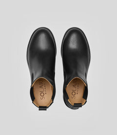 Vegan Chelsea boots - Woman viewed from above, showcasing their sleek black design and elegant style.