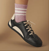 Black and white vegan Barefoot sneaker with a pink striped sock, sustainable, plant-based leather