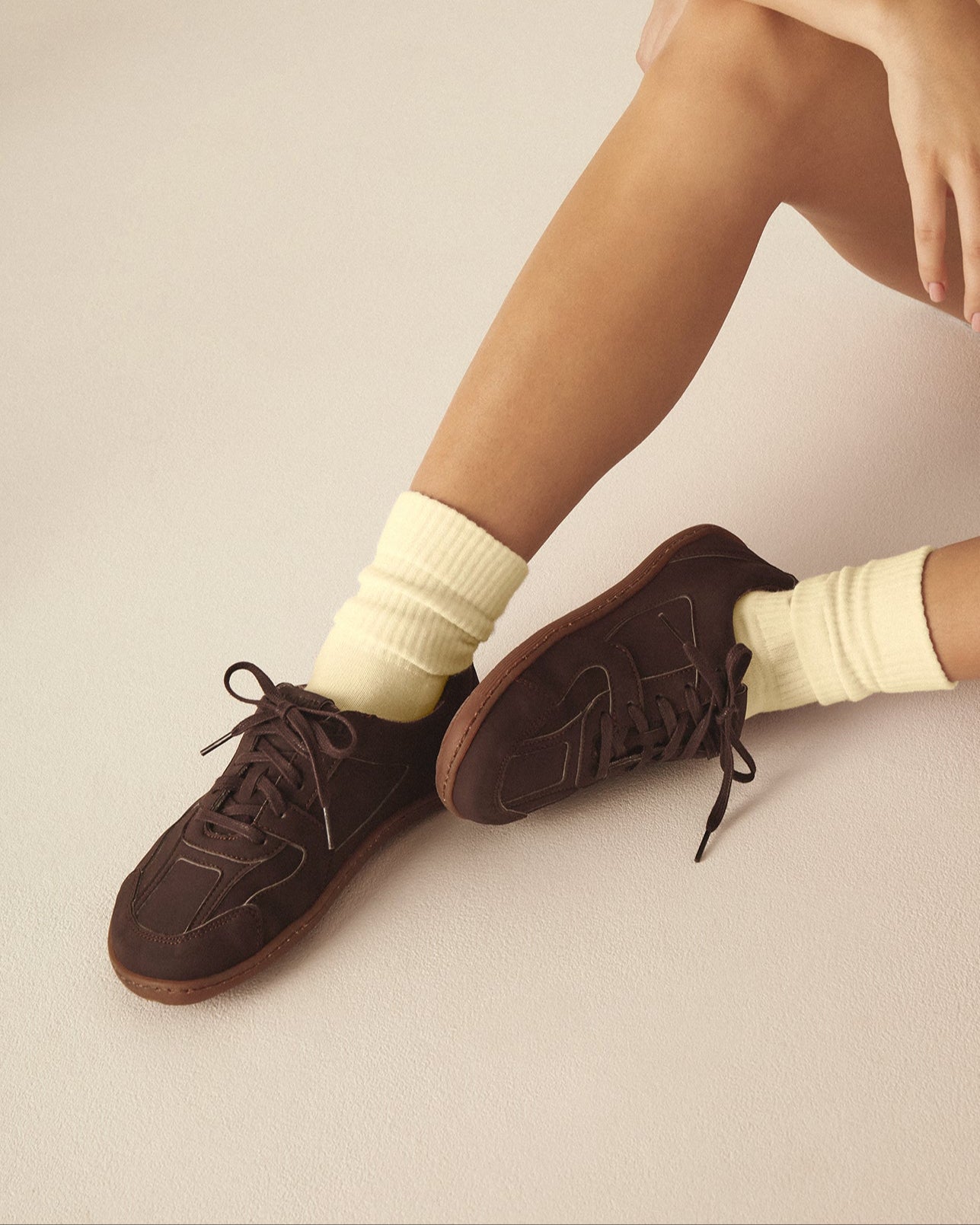 Person wearing brown barefoot shoes made from vegan leather.