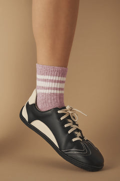 Black and white barefoot sneaker with a striped sock in vegan leather.