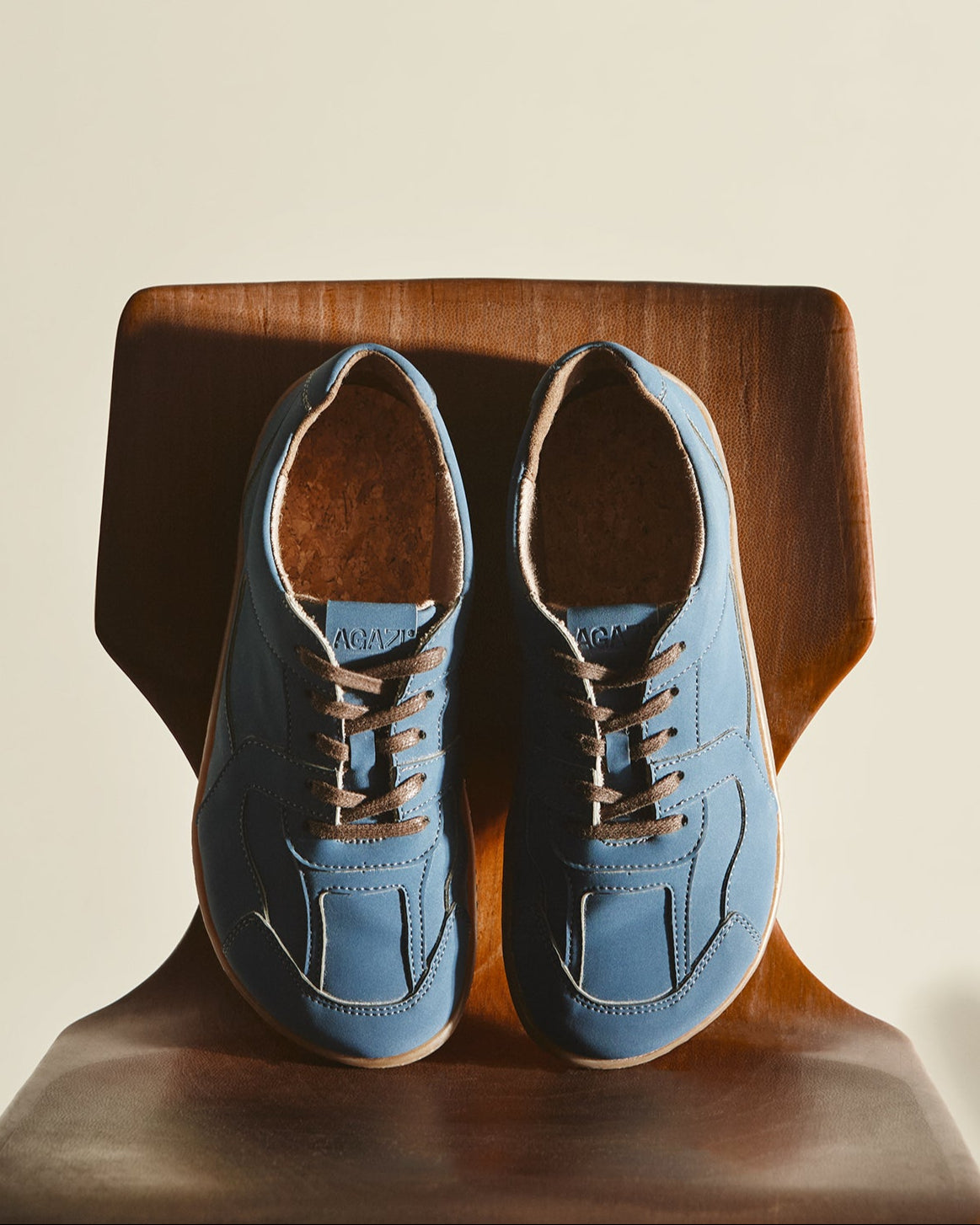 Pair of blue barefoot sneakers in vegan leather. Sustainable and cruelty-free.