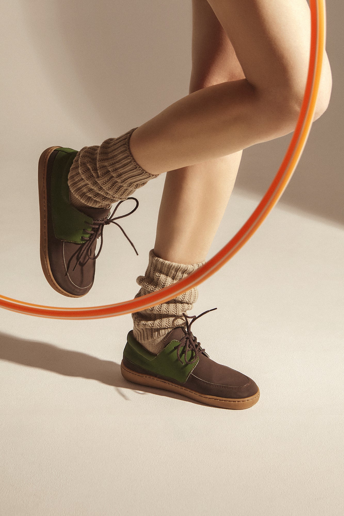 Woman wearing brown barefoot shoes in vegan leather. Sustainable and cruelty-free.