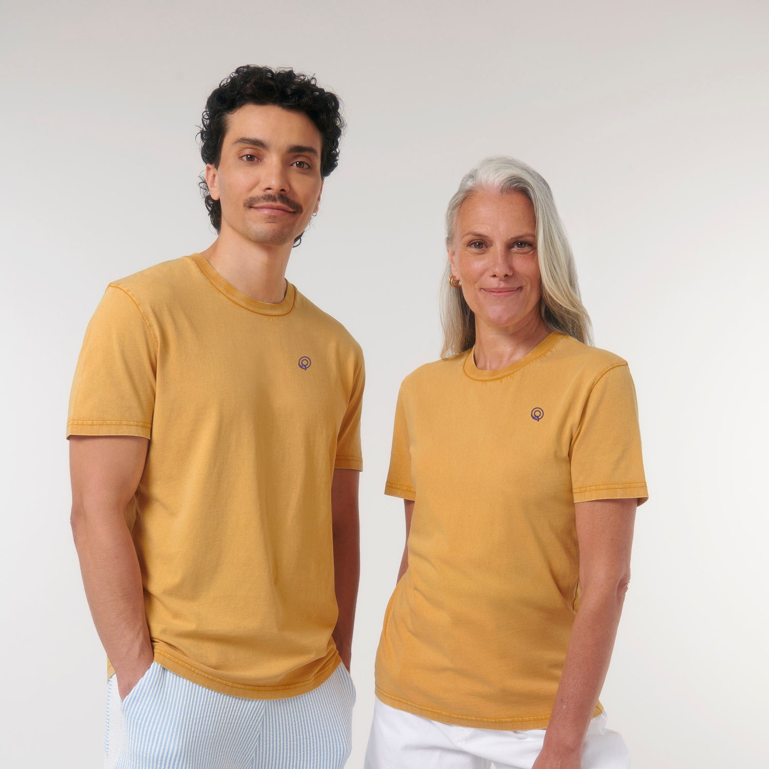 Models wearing vintage-style gold ochre t-shirt made from sustainable organic cotton – eco-friendly fashion by New World Guardians