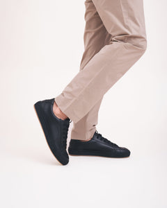 black vegan sneakers with beige trousers stylish tendance