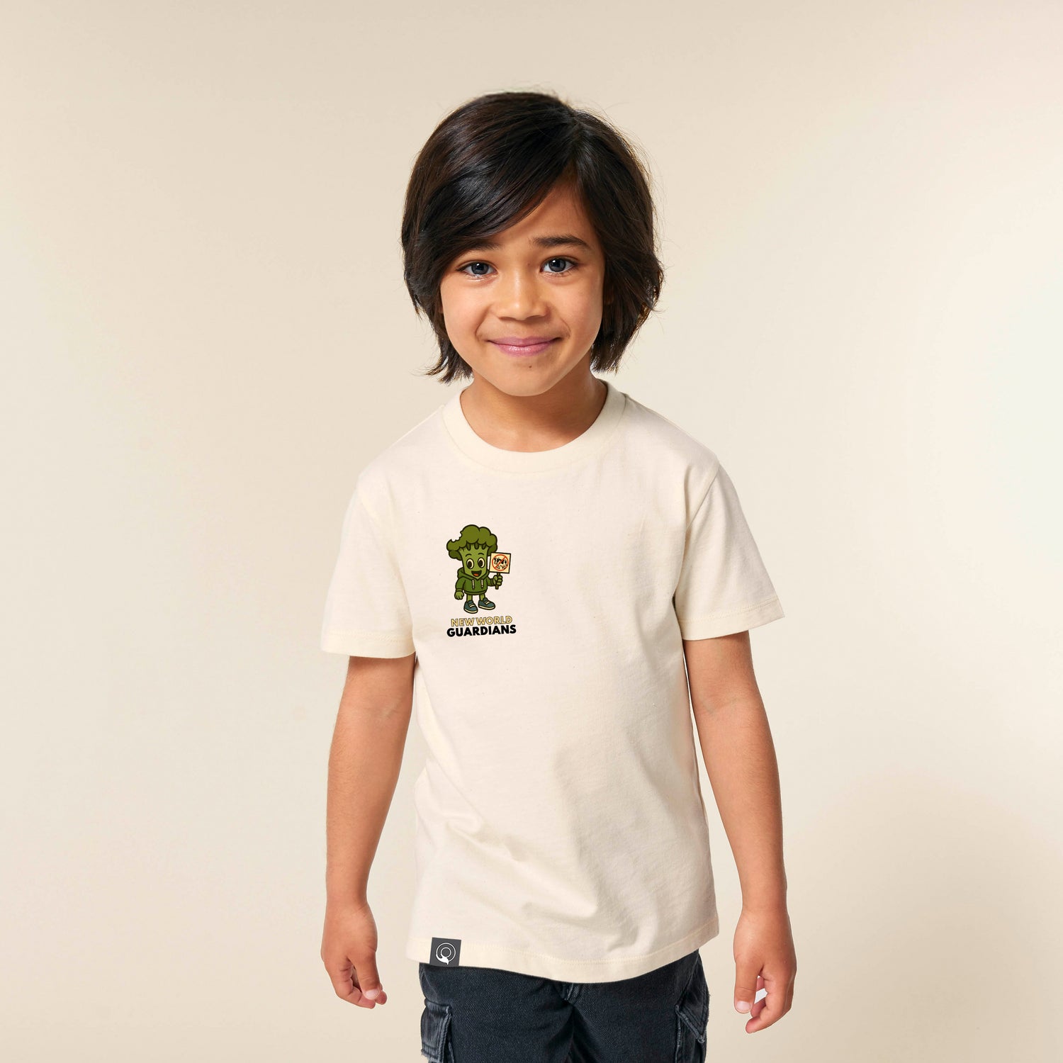 Child in beige sustainable kids t-shirt with Steamy veganhero print, Roots for Our Future Collection