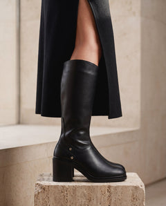 BETIA Black vegan knee-high heeled boot pair — women's vegan tall boot in black with harness strap detail and block heel