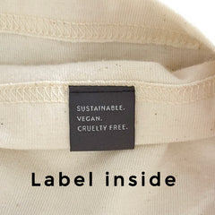 Label on NEW WORLD GUARDIANS T-Shirt with text 'Sustainable. Vegan. Cruelty Free.'