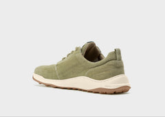 Green sneaker on a light gray background