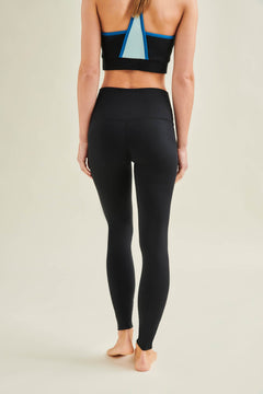 Model wearing Wellicious Fresher Cropped Tank and high waist black leggings made from non toxic biodegradable materials