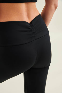 Back view of woman wearing black sustainable and eco-friendly yoga leggings from Wellicious — circular, non-toxic, microplastic-free activewear