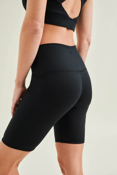 Model wearing Wellicious black Control Bra and high waist shorts made from organic cotton and biodegradable elastane