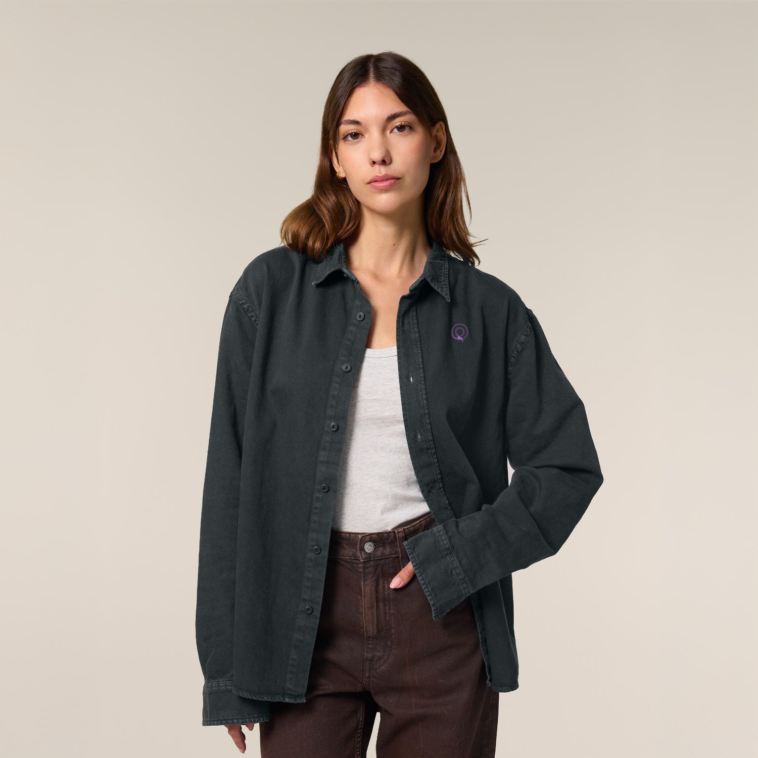 Female model wearing a black worker shirt – sustainable and ethically made fashion by New World Guardians.